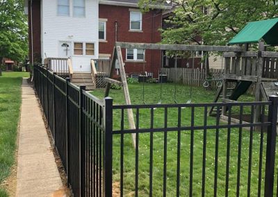 black aluminum fence around a back yard